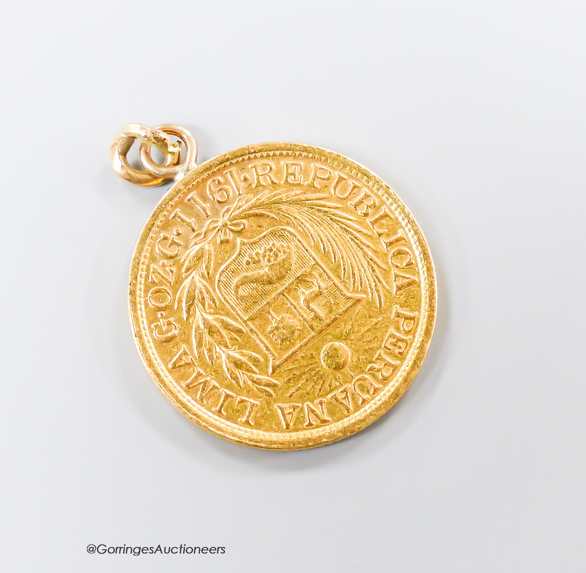 A 1911 Peruvian gold coin, now mounted as a pendant, 8.2 grams.